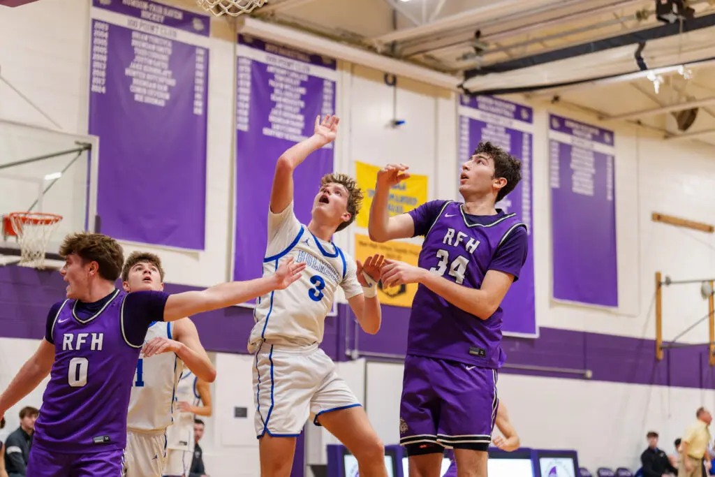 Holmdel at Rumson - Shore Sports Insider Holmdel senior Connor Paul puts up a shot over Rumson-Fair Haven seniors Luke Lydon (left) and Luke Cruz (Photo: Patrick Olivero) - Holmdel at Rumson