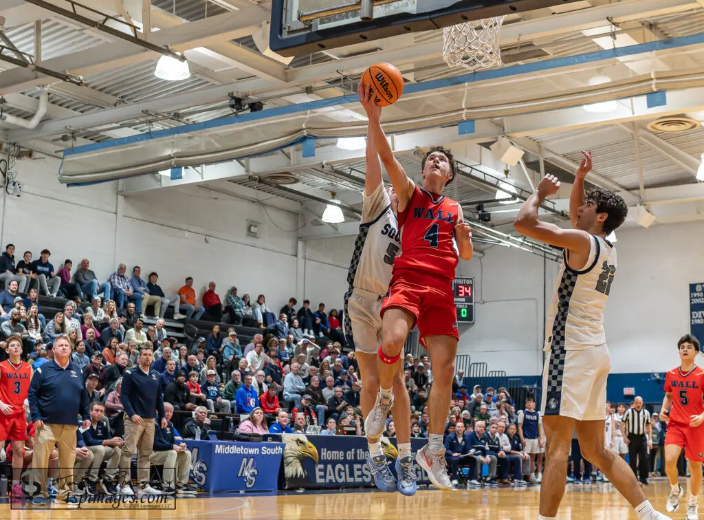 Wall vs Manasquan SCT - Shore Sports Insider Wall senior Dan Hennessy skies to the rim against Manasquan defenders Kennedy Larned (left) and Logan Cleveland. (Photo: Tom Smith | tspsportsimages.com) - Wall vs Manasquan SCT