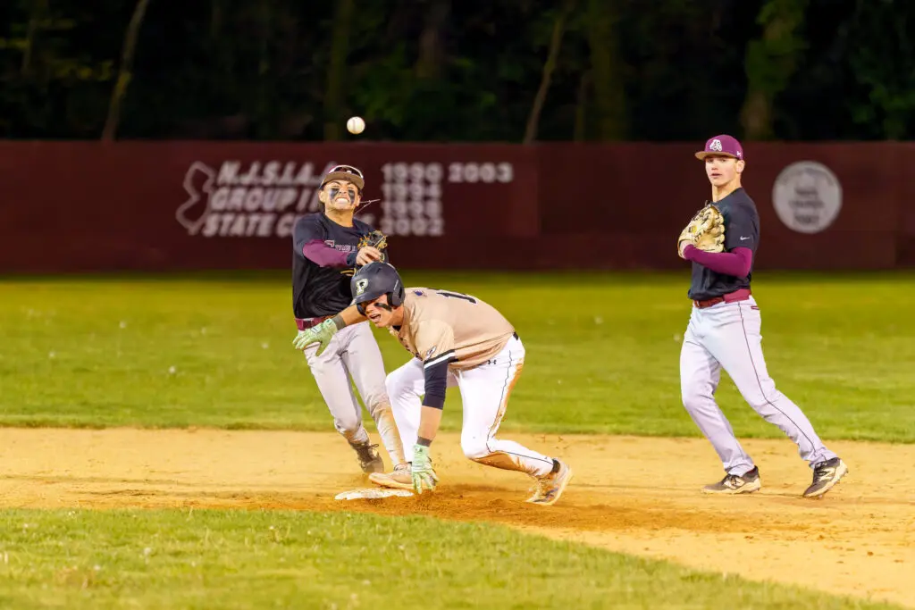 TR South vs PtBoro - Shore Sports Insider Toms River South junior Christian Mascaro throws the ball to first base over Point Boro senior James Bradley. (Photo: Patrick Olivero) - TR South vs PtBoro