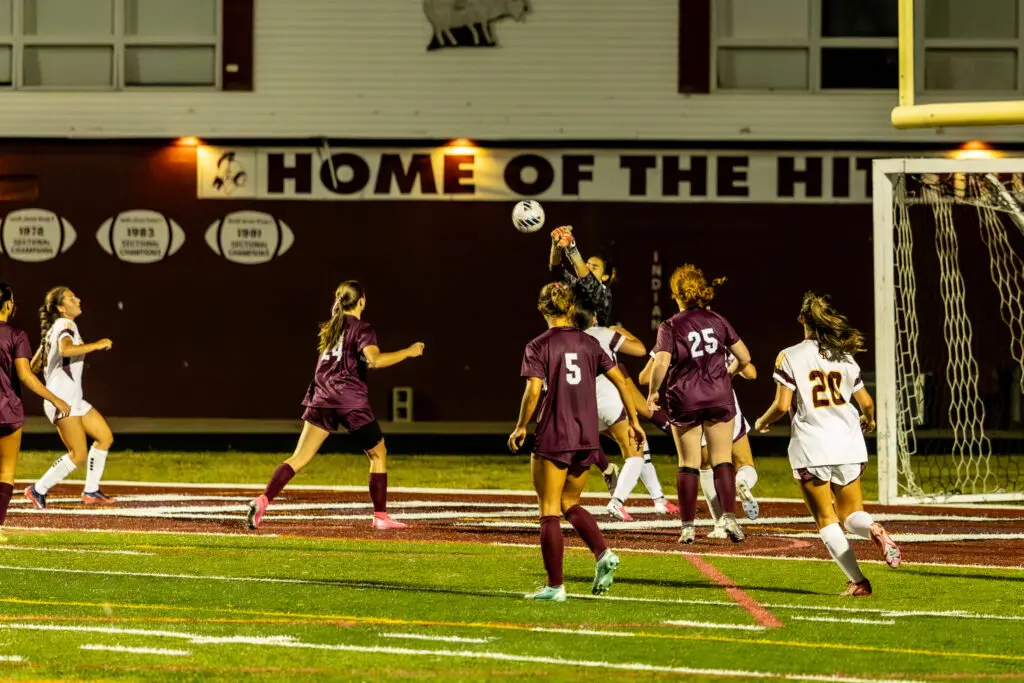 TRS Lindemann save1 - Shore Sports Insider Reese Lindemann makes a save in the second-half against No. 3 Central. 9/15/26 (Photo by Doug Phillips/Framegrabs LLC) - TRS Lindemann save1' soccer team near the goal as the goalkeeper jumps to catch the ball during a night match.
