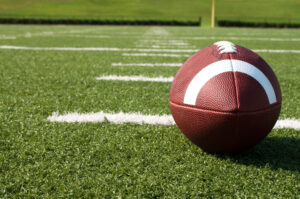  - Closeup of American Football on Field (stock)