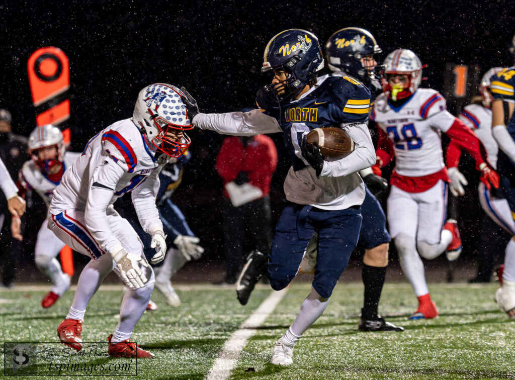 Toms River North senior Nasir Jackson stiff arms a Washington Township defender. (Photo: Tom Smith | tspimages.com) - Nasir Jackson, Toms River North Football