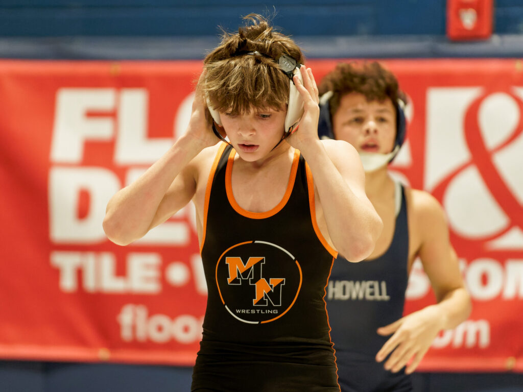 Middletown North's Thomas Blewett adjusts his head gear during the 2024 Shore Conference Tournament 106-pound quarterfinals at Middletown High School South. (Bob Badders | rpbphotography.com)