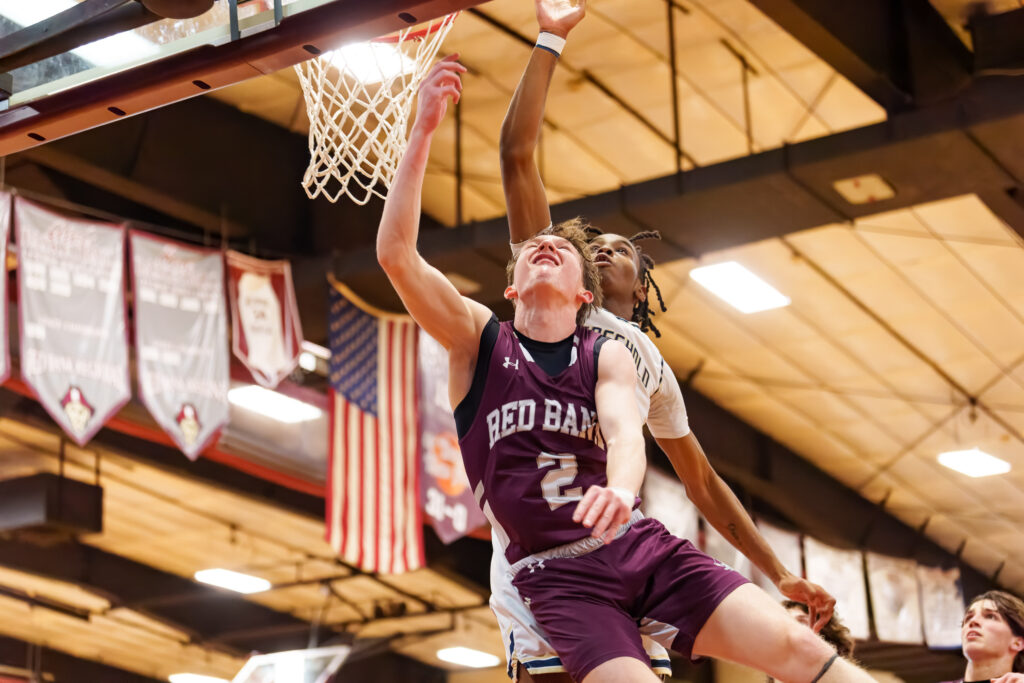 Red Bank senior Ryan Fisher goes up for a score as Freehold Boro senior Qua'Mir Everett contests the shot. (Photo by Patrick Oliveira) - Freehold Boro at Red Bank