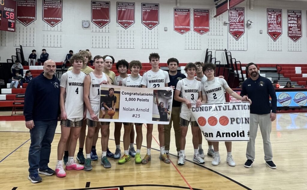 Nolan Arnold (23) celebrates his 1,000-point milestone with his New Egypt teammates. (Photo provided by Mick Hughes/New Egypt Boys Basketball) - Nolan Arnold New Egypt 1000