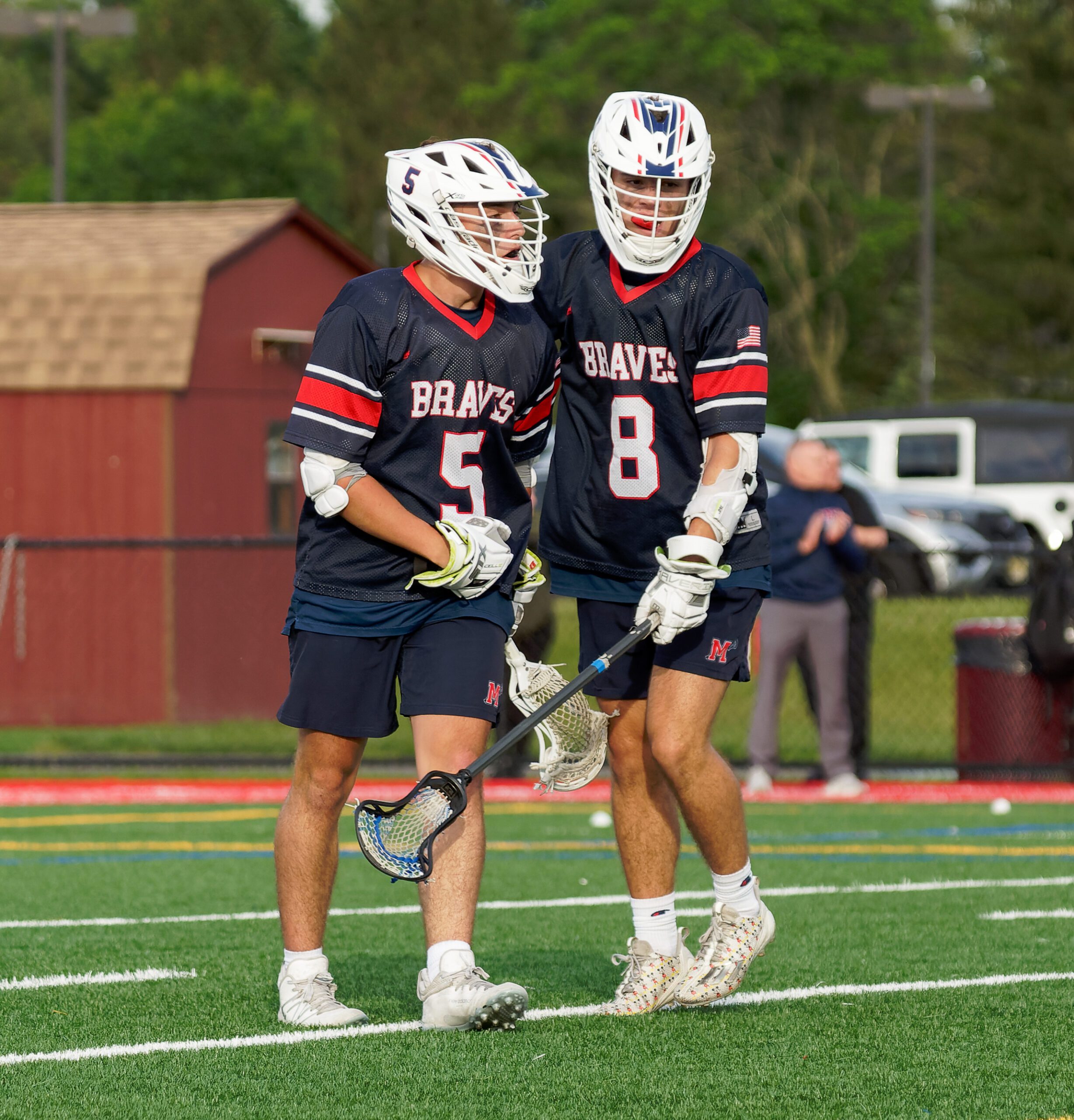 Anthony Tufte (5) and Nick Tufte (8) celebrate a goal during Manalapan's 8-6 win over Monroe in the first round of the 2025 NJSIAA South Group 4 boys lacrosse state playoffs.  (Bob Badders | rpbphotography.com). - Anthony Tufte (5) and Nick Tufte (8), Manalapan boys lacrosse