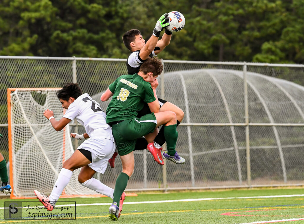 Long Branch Gerardo Rodas - Shore Sports Insider Long Branch senior Goalkeeper Gerardo Rodas grabs the free kick as Brick Memorial sophomore Matt Heptig crashes into him. (Photo Credit: Tom Smith | tspsportsimages.com) - Long Branch Gerardo Rodas