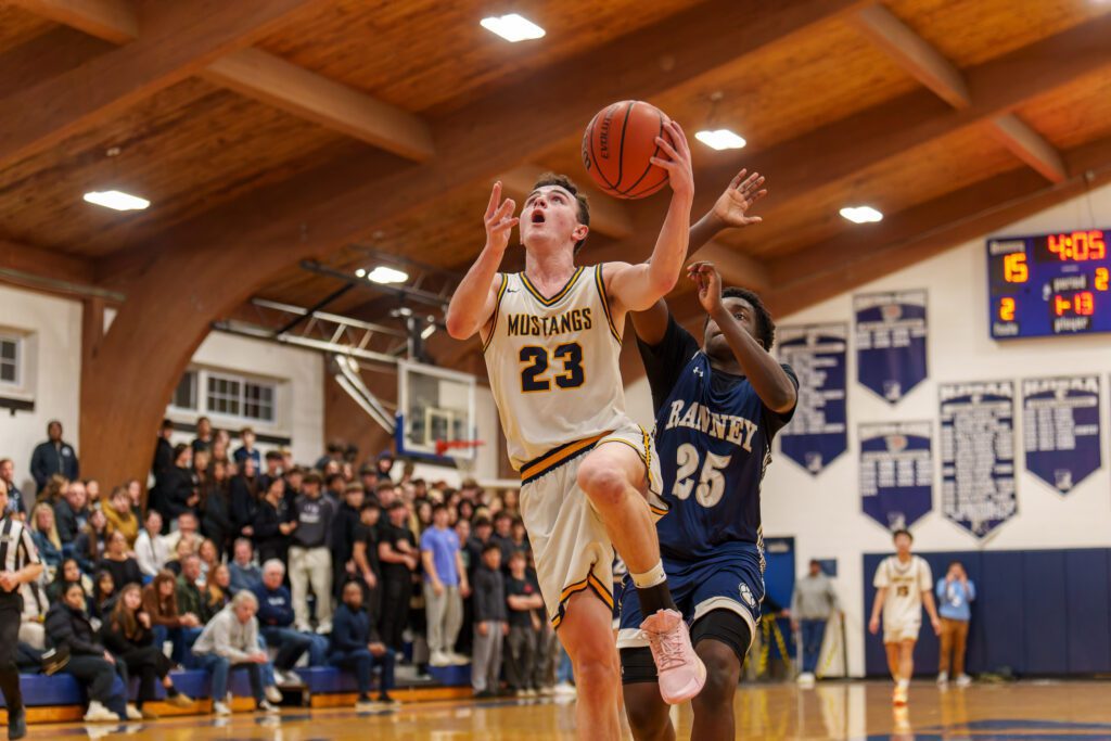 Marlboro junior Dylan McEwan lines up a layup attempt with Ranney sophomore Eyan Antoine in pursuit. (Photo: Patrick Olivero) - Marlboro at Ranney
