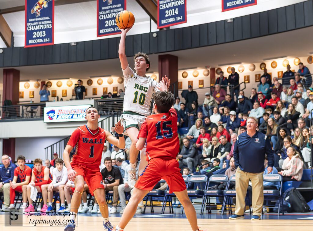 Red Bank Catholic senior James Hankowski lofts a shot over Wall senior Liam Killea (15) as Wall senior Jake DeBrito looks on. (Photo: Tom Smith | tspsportsimages.com) - RBC Hankowski