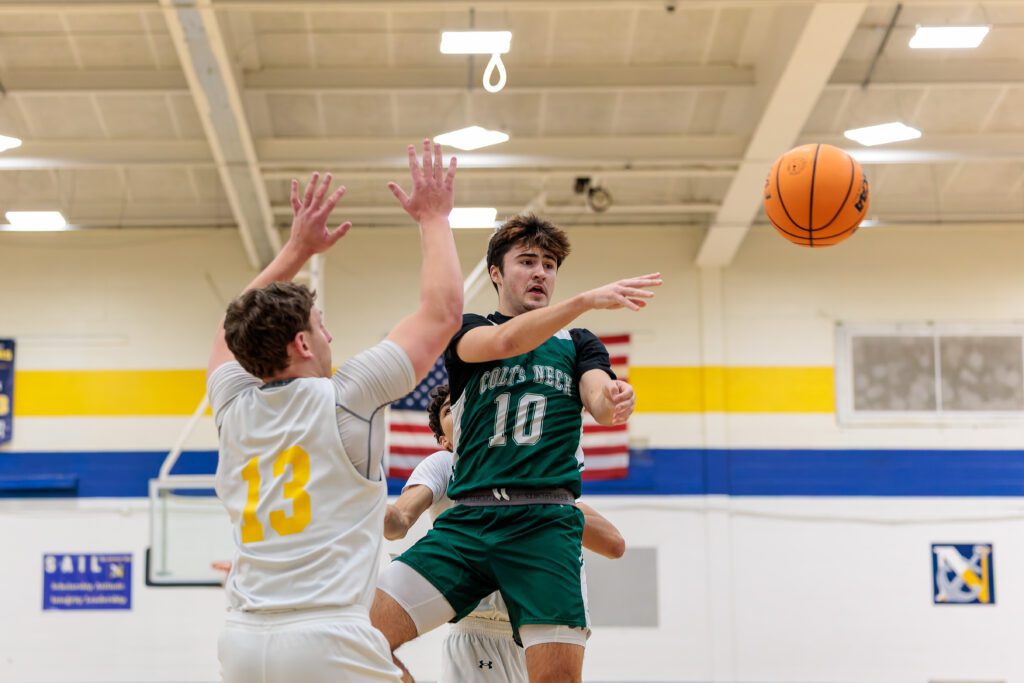 Colts Neck senior Dillon Younger looks for a teammate while guarded by Toms River North senior Bryce Kazanowsky. (Photo: Patrick Olivero) - Colts Neck vs. TR North