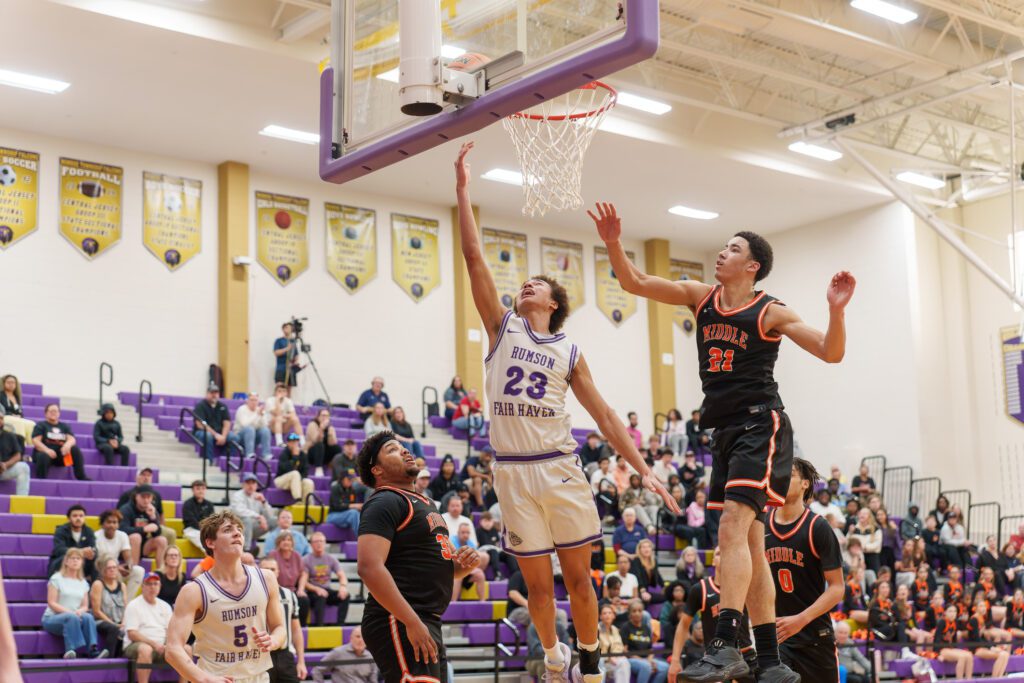 Rumson-Fair Haven freshman Clint Martin scores between Middle senior Alex Daniel (left) and junior Kanye Perkins. (Photo: Patrick Olivero) - Rumson vs Middle