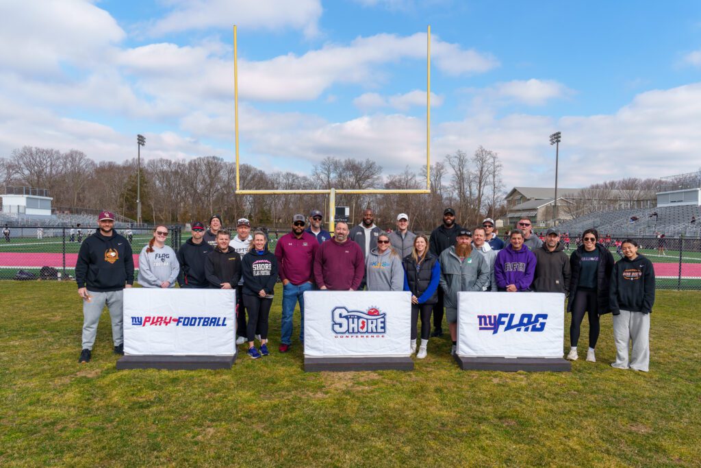 The Shore Conference Girls Flag Football Coaches pose for a picture with New York Giants' Chris Manhertz and Andrew Thomas (Photo by Patrick Olivero) - Event Organizers