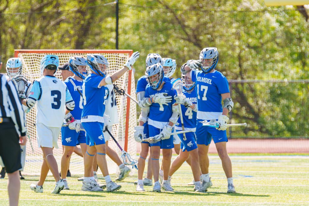 Holmdel's James Esposito (#1) is mobbed by his teammates after a goal (Photo by Patrick Olivero) - Holmdel James Esposito