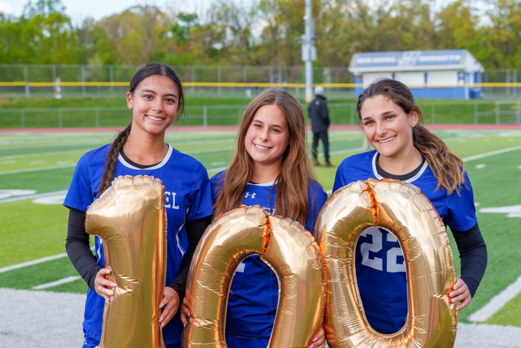 Holmdel's Avery Dubin (pictured in the middle) scored her 100th career point against Point Boro (Photo by Patrick Olivero) - Holmdel Avery Dubin