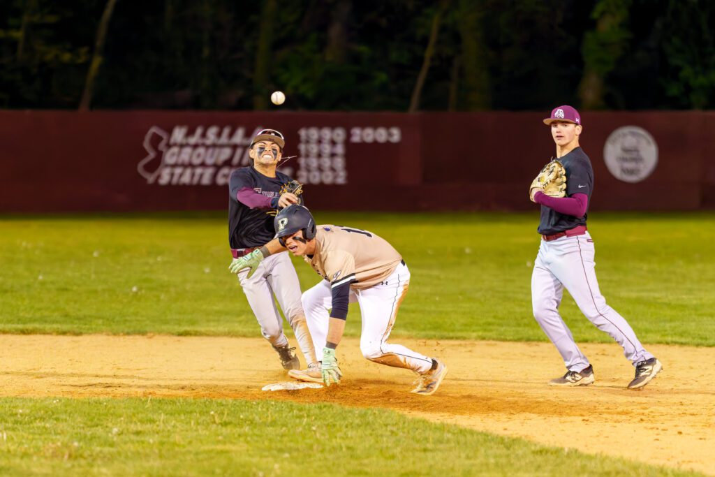 Toms River South junior Christian Mascaro throws the ball to first base over Point Boro senior James Bradley. (Photo: Patrick Olivero) - TR South vs PtBoro